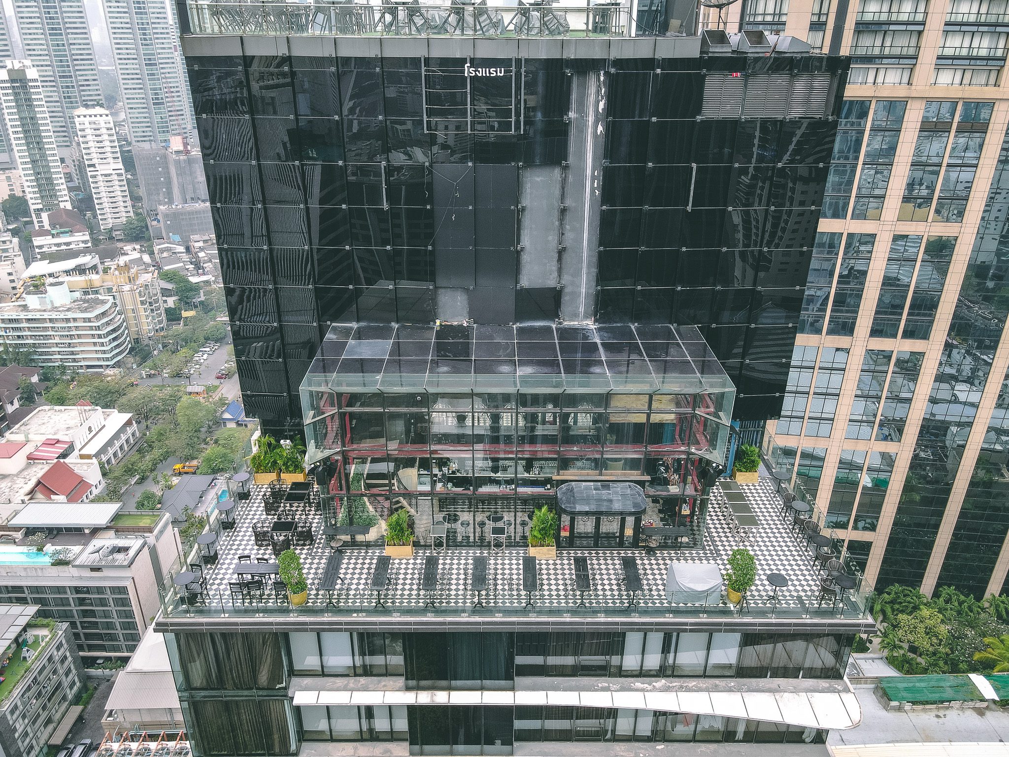 Rooftop terrace with seating on a high-rise building in Bangkok, Thailand.