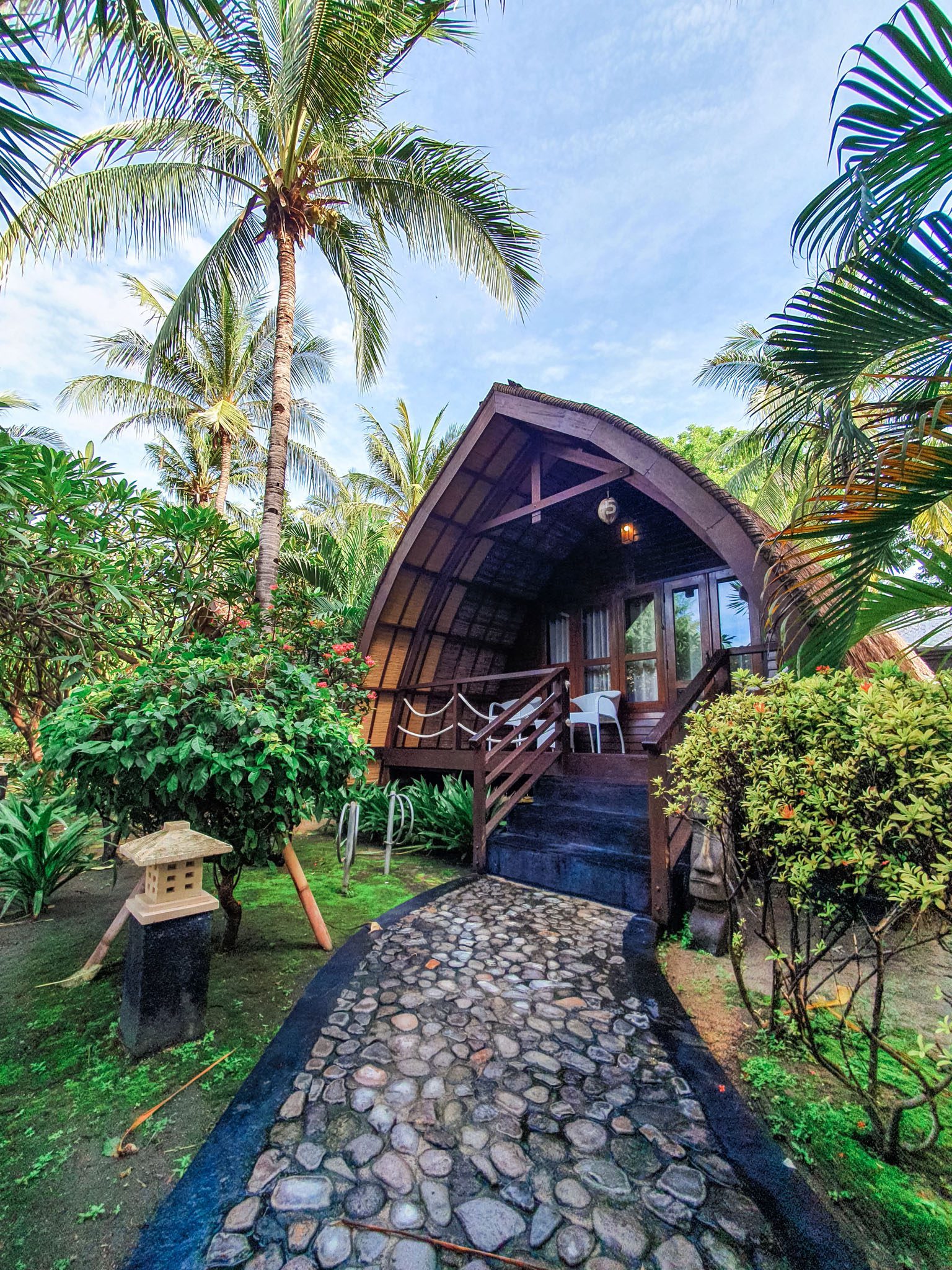 Tropical cabin surrounded by lush greenery in the Gili Islands.