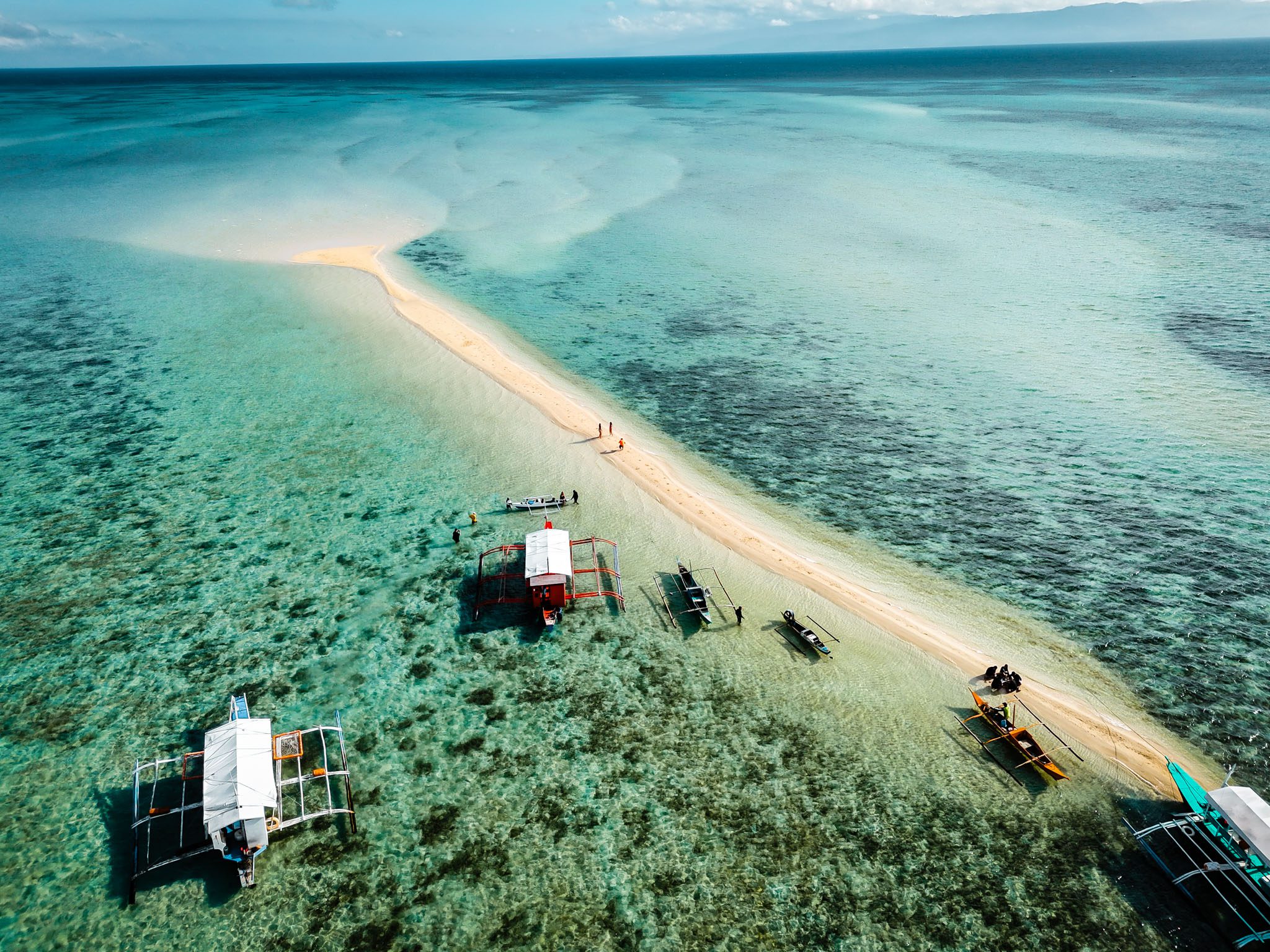 Aerial view of a sandbar with boats in clear waters near Dumaguete, Philippines.