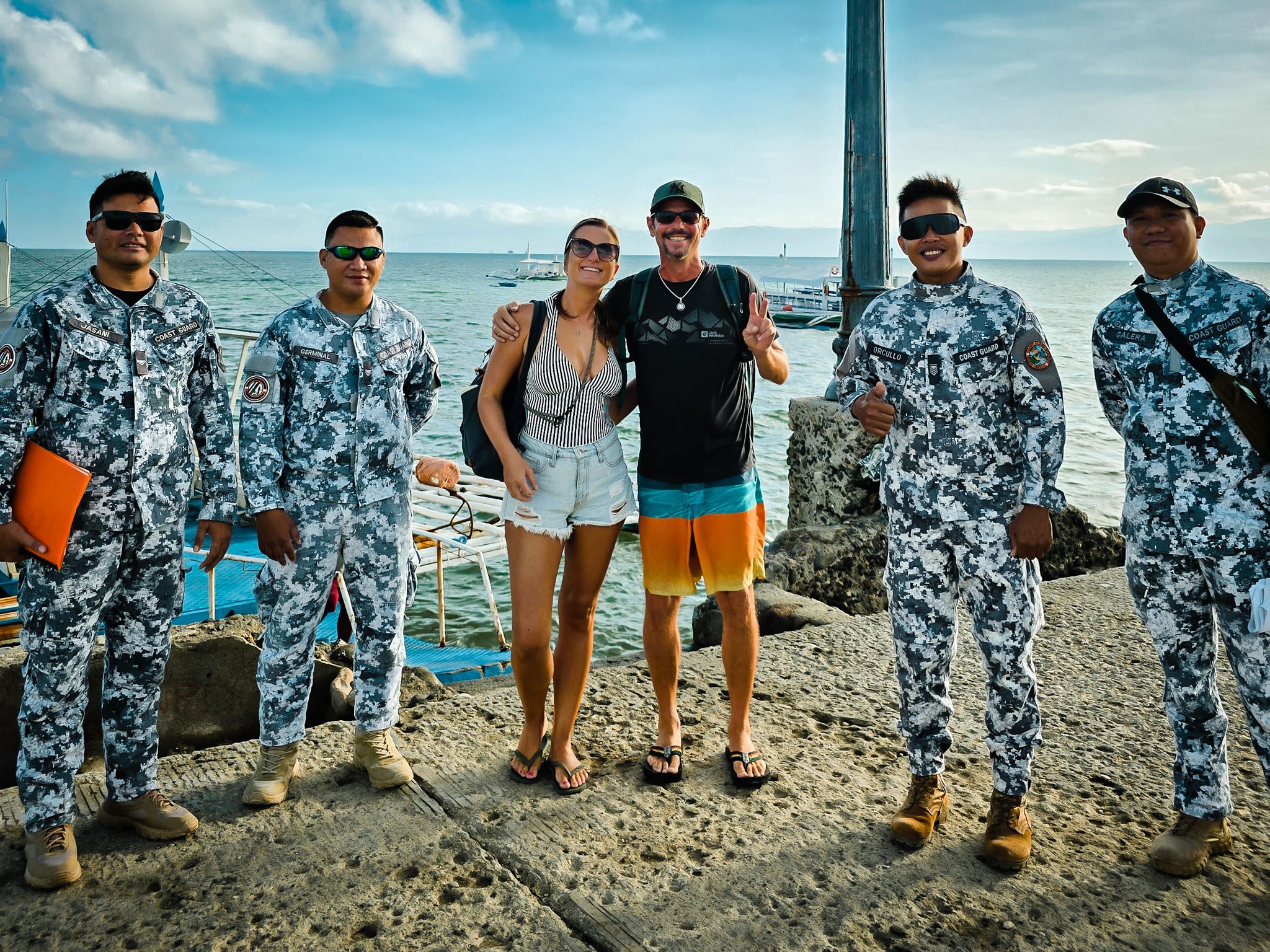 Group photo with Philippine Coast Guard in Dumaguete by the seaside.