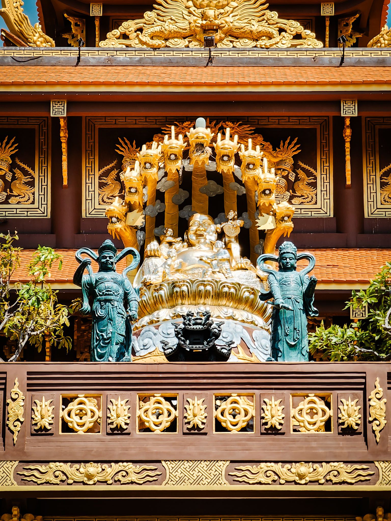 Ornate Buddhist temple facade with dragon motifs in Mui Ne, Vietnam.