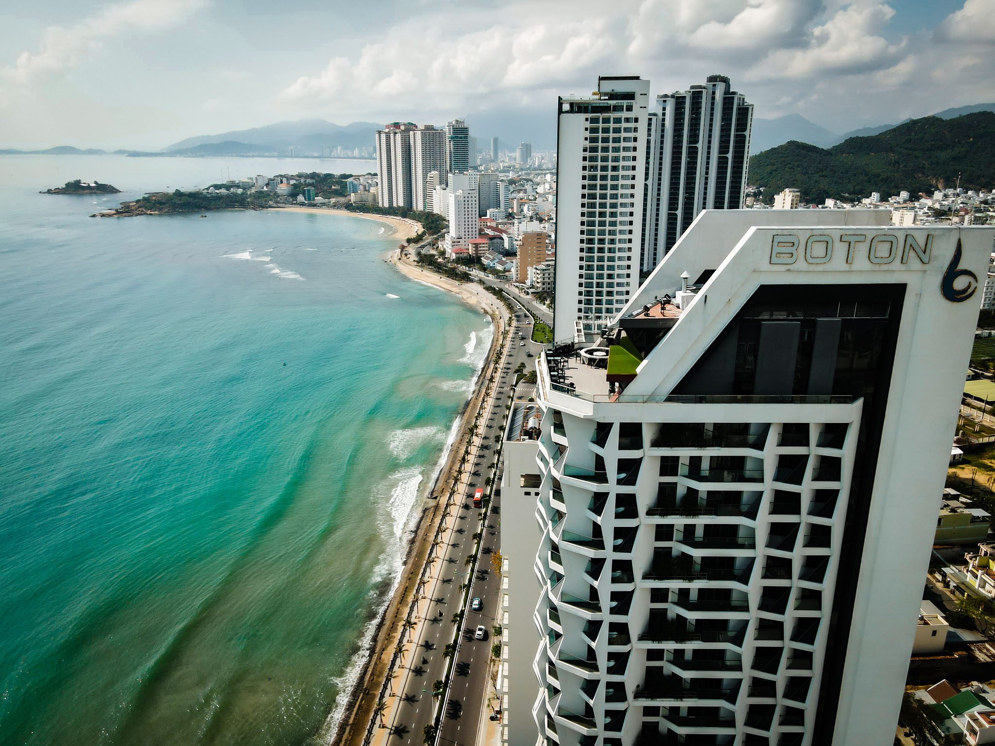 Aerial view of beachfront hotels and coastline in Nha Trang, Vietnam.